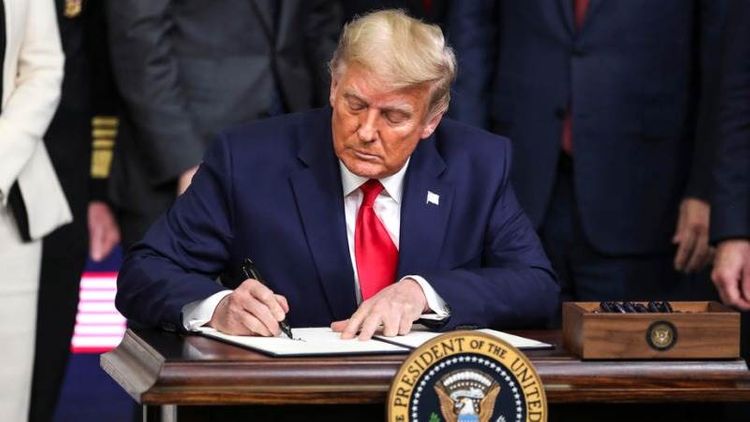 Trump signs relief and spending package into law
